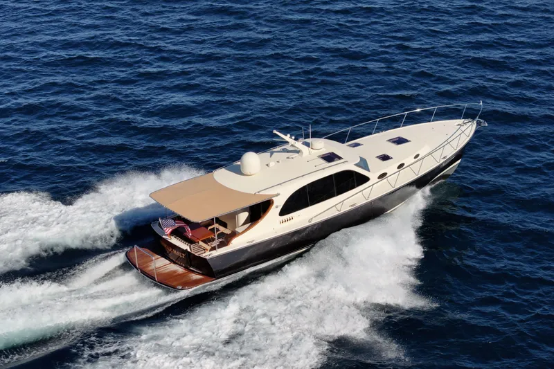 Slide: The Image of 2015 Palm Beach Motor Yachts PB45 cruising on open water, showcasing sleek design and performance. - 7