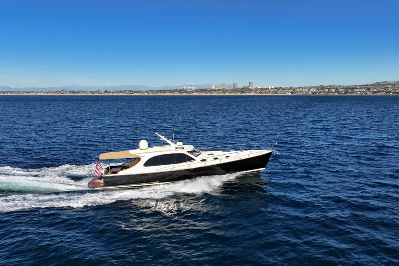 Slide: The Image of 2015 Palm Beach Motor Yachts PB45 cruising on open water under clear blue skies. - 10
