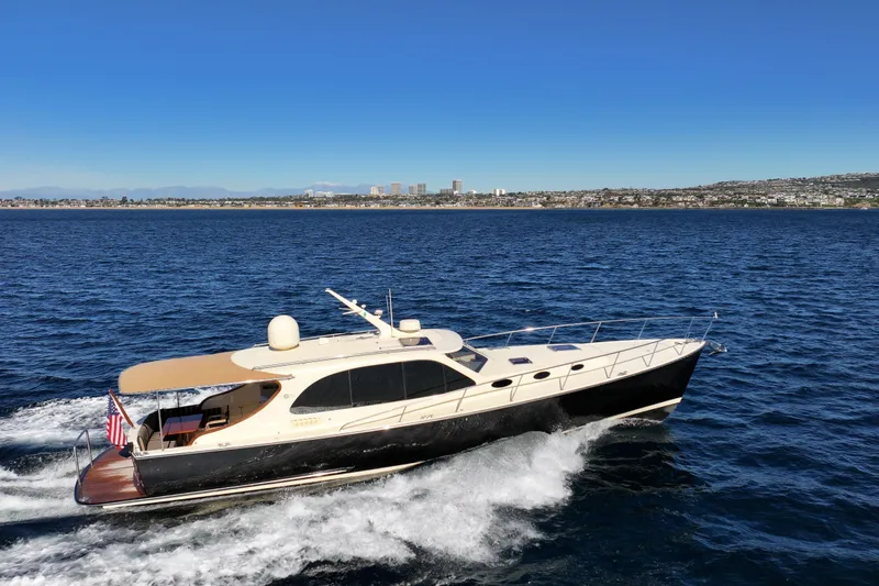 Slide: The Image of 2015 Palm Beach Motor Yachts PB45 cruising on open water under clear blue skies. - 11