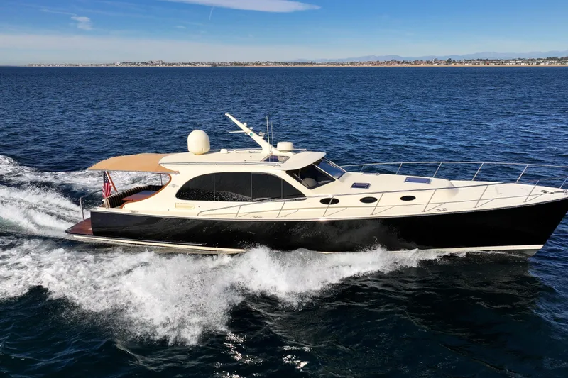 Slide: The Image of 2015 Palm Beach Motor Yachts PB45 cruising on open water under clear skies. - 12