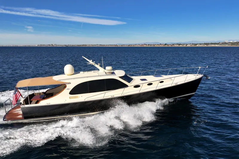 Slide: The Image of 2015 Palm Beach Motor Yachts PB45 cruising on open water under clear blue skies. - 15
