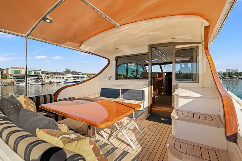 Slide: The Image of 2015 Palm Beach Motor Yachts PB45 interior with elegant seating and wooden table. - 26
