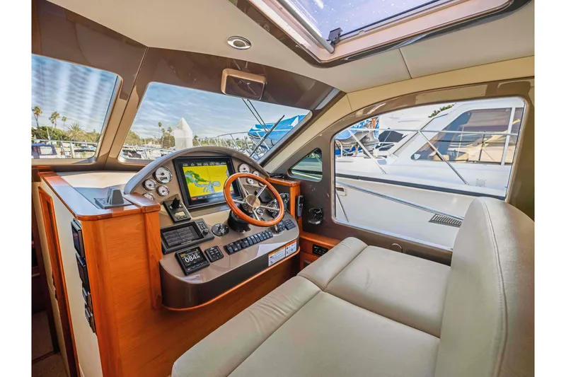 Slide: The Image of Interior of 2015 Palm Beach Motor Yachts PB45 helm with navigation system and leather seating. - 44