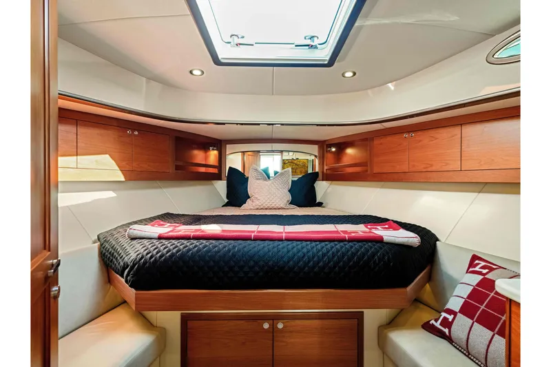 Slide: The Image of Luxurious cabin interior of 2015 Palm Beach Motor Yachts PB45 with elegant bedding and wood finish. - 54
