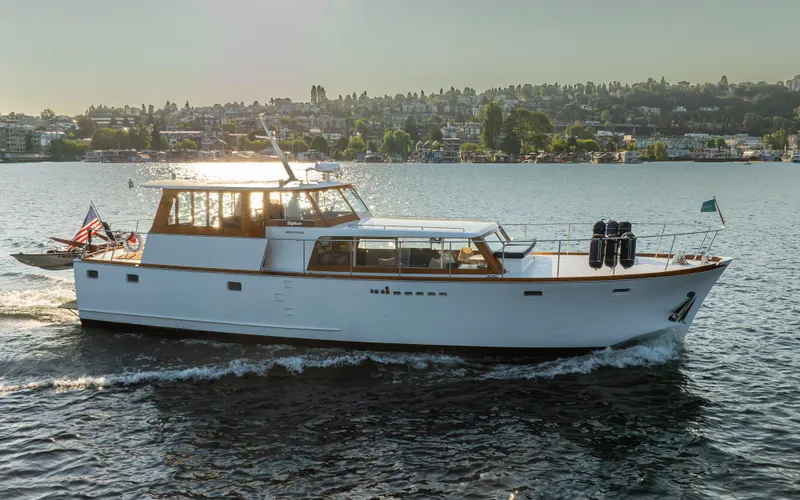 Slide: The Image of 1965 Stephens Flushdeck yacht cruising on calm waters at sunset. - 1