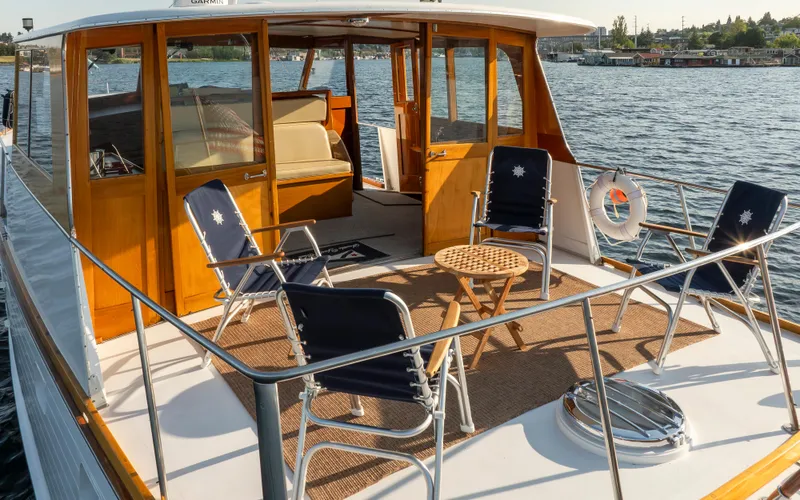 Slide: The Image of 1965 Stephens Flushdeck yacht with deck furniture on calm water. - 10