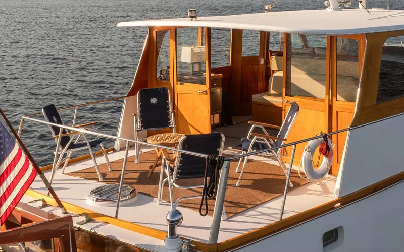 Slide: The Image of 1965 Stephens Flushdeck yacht with seating area and American flag. - 11