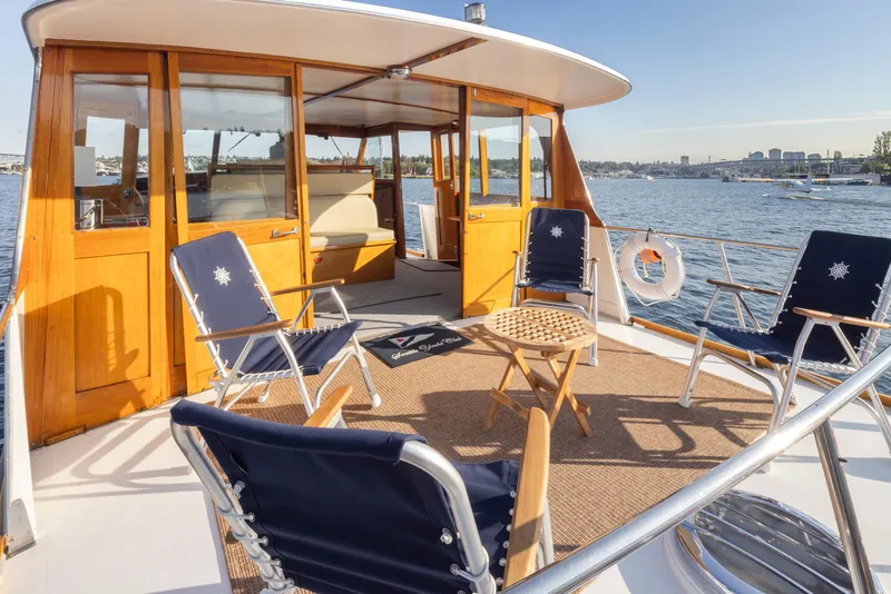 Slide: The Image of 1965 Stephens Flushdeck yacht with deck chairs on the water. - 12