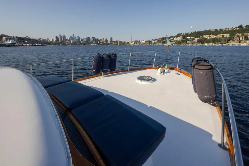Slide: The Image of 1965 Stephens Flushdeck yacht on calm water with city skyline. - 16
