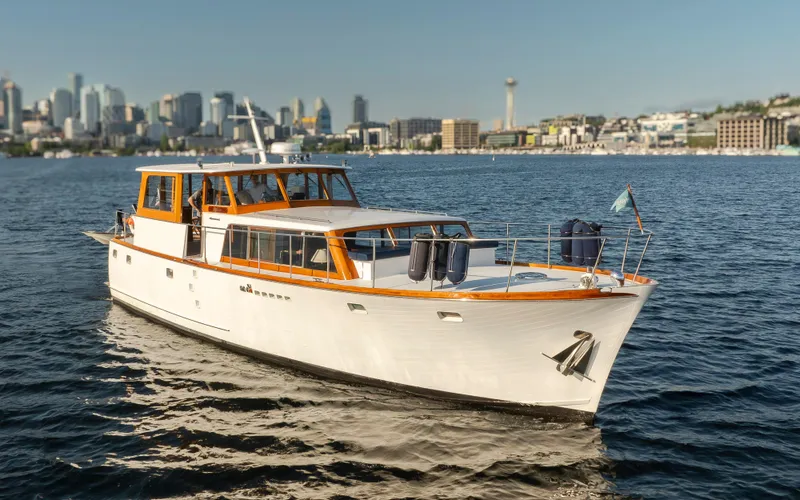 Slide: The Image of 1965 Stephens Flushdeck yacht cruising near city skyline. - 2