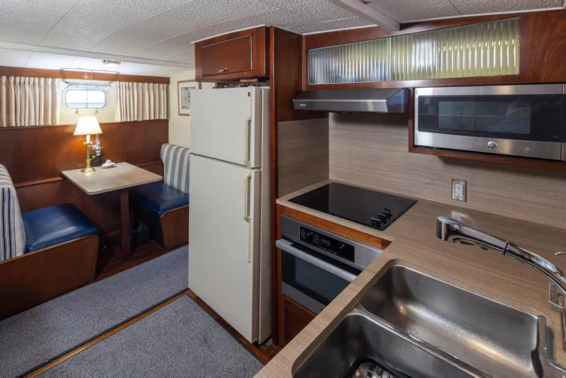 Slide: The Image of Interior of a 1965 Stephens Flushdeck yacht with kitchen and dining area. - 32