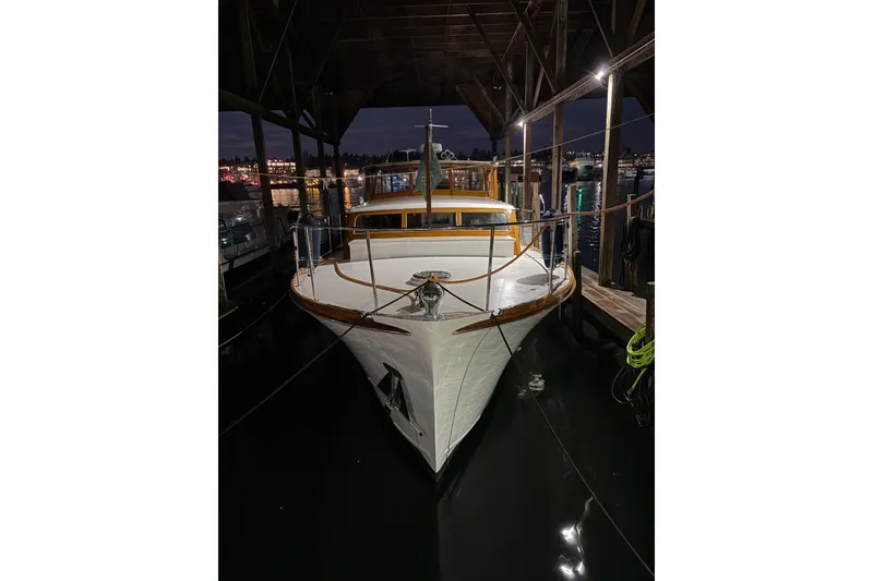 Slide: The Image of 1965 Stephens Flushdeck yacht docked at night under a covered marina. - 45