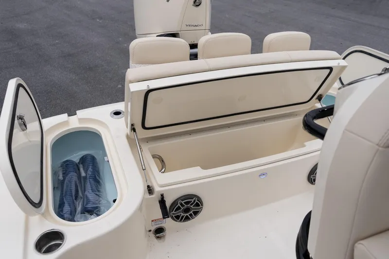 Slide: The Image of 2026 Scout 231 XSB boat interior with open storage compartments and seating. - 10