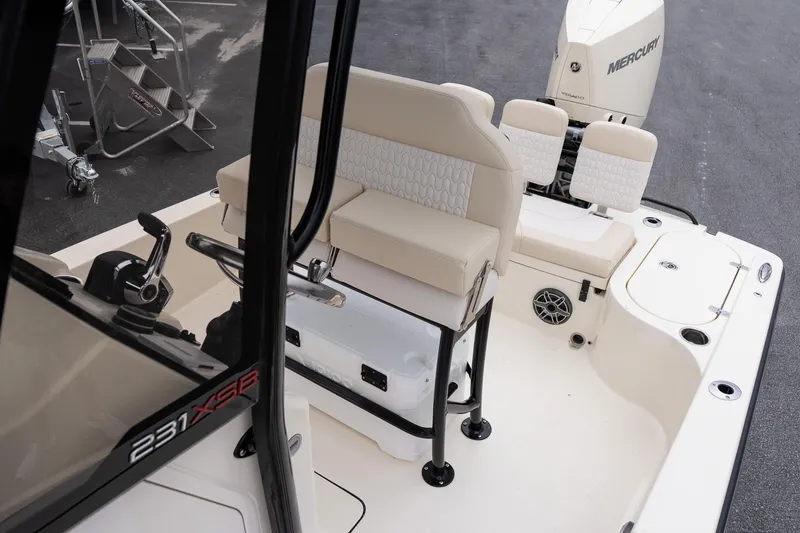 Slide: The Image of 2026 Scout 231 XSB boat interior with seating and Mercury engine. - 12