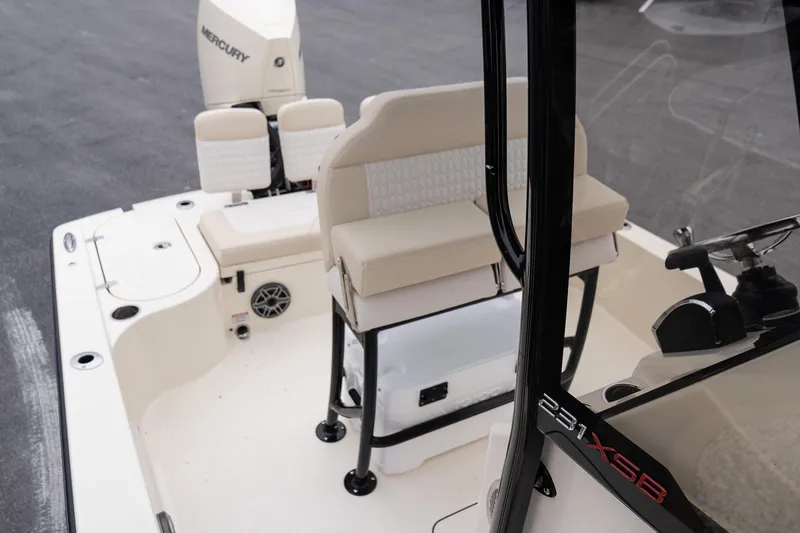 Slide: The Image of 2026 Scout 231 XSB boat interior with seating and Mercury engine. - 13