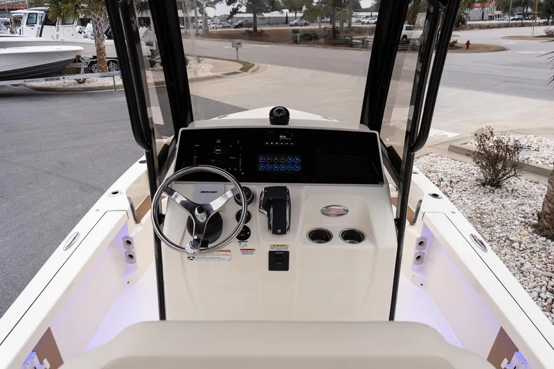 Slide: The Image of 2026 Scout 231 XSB boat dashboard with steering wheel and control panel. - 15