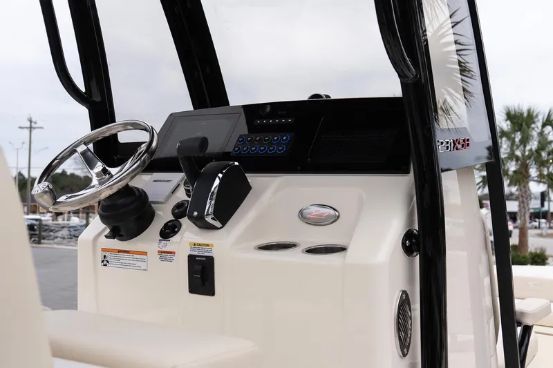 Slide: The Image of 2026 Scout 231 XSB boat dashboard with steering wheel and control panel. - 17