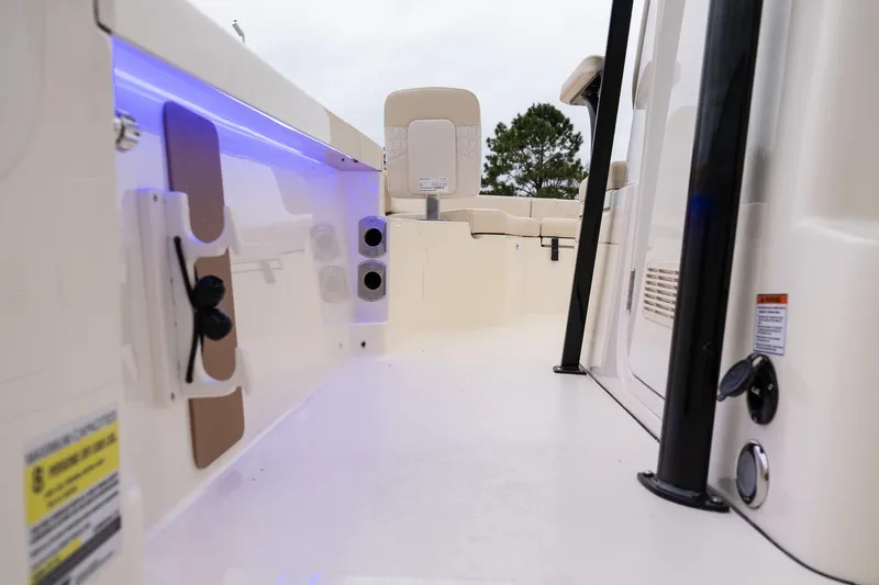 Slide: The Image of 2026 Scout 231 XSB boat interior with seating and blue LED lighting. - 18