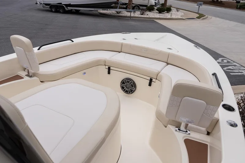 Slide: The Image of 2026 Scout 231 XSB boat interior with beige seating and speaker system. - 21