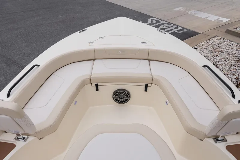 Slide: The Image of 2026 Scout 231 XSB boat interior with beige seating and speaker system. - 24