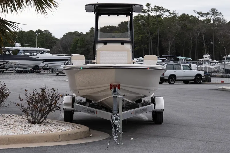 Slide: The Image of 2026 Scout 231 XSB boat on trailer in marina parking lot. - 4