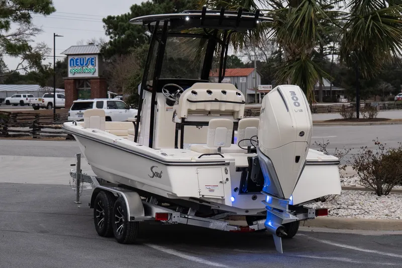 Slide: The Image of 2026 Scout 231 XSB boat on trailer, parked near Neuse Sport Shop. - 5