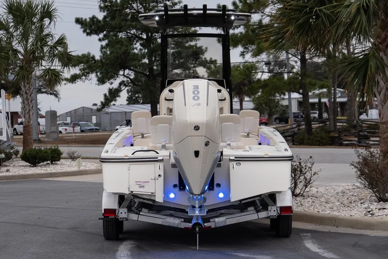 Slide: The Image of 2026 Scout 231 XSB boat on trailer, rear view with powerful engine. - 6