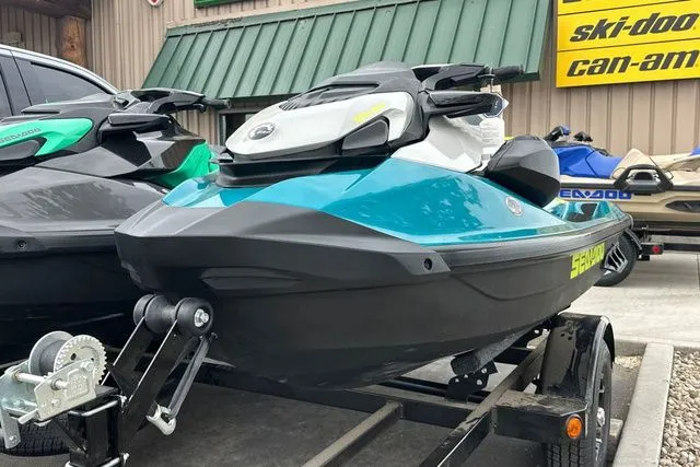 Slide: The Image of 2026 Sea-Doo GTI jet ski on trailer, blue and black, parked outdoors. - 19
