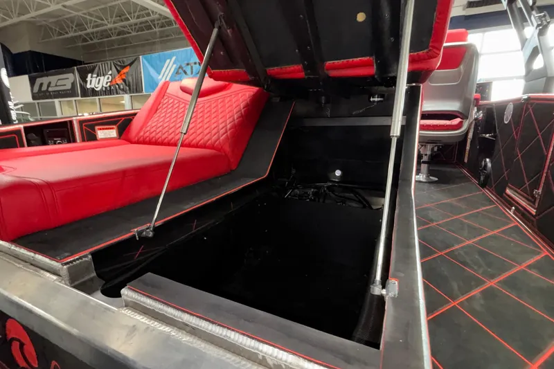 Slide: The Image of Red and black interior of 2026 Anthem Assault VF23 boat with open storage compartment. - 19