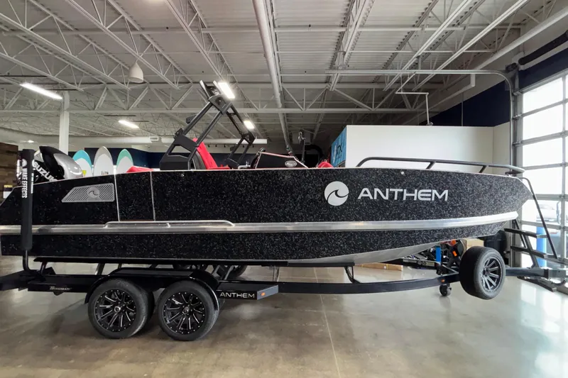 Slide: The Image of 2026 Anthem Assault VF23 boat displayed indoors on a trailer. - 7