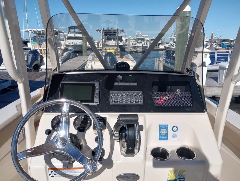 Slide: The Image of Helm console of a 2022 Scout 215 XSF boat in marina. - 15