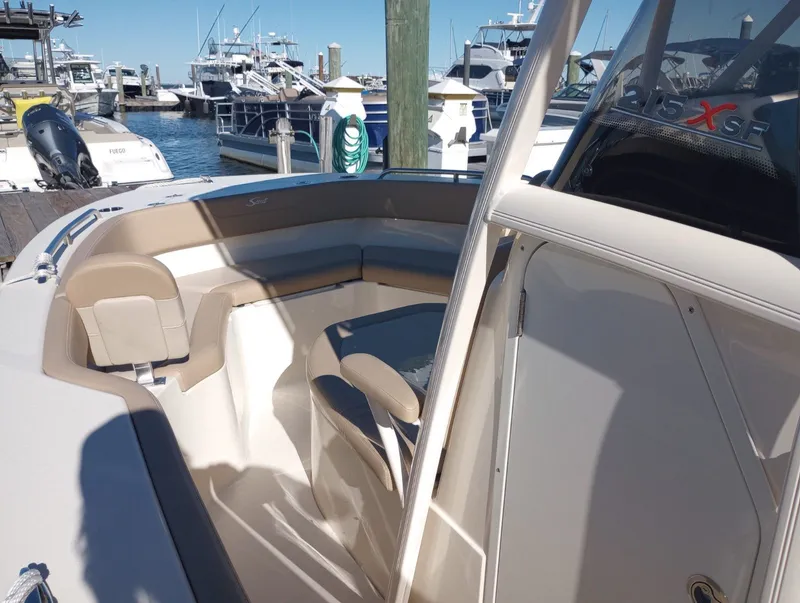 Slide: The Image of Scout 215 XSF 2022 boat at dock with seating area. - 17