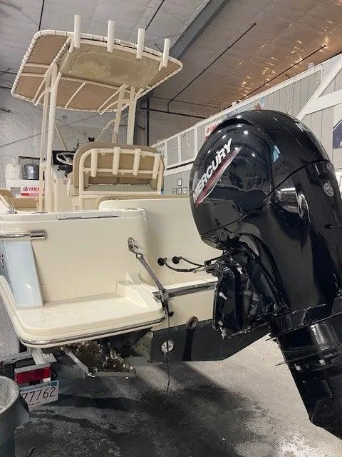 Slide: The Image of Scout 215 XSF 2022 with Mercury outboard motor in a storage facility. - 3