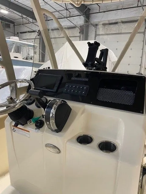 Slide: The Image of 2022 Scout 215 XSF boat console in a warehouse setting. - 4