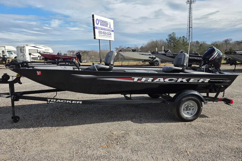 The Image of 2025 Tracker Panfish 17 boat on trailer at dealership, clear sky background. - 0