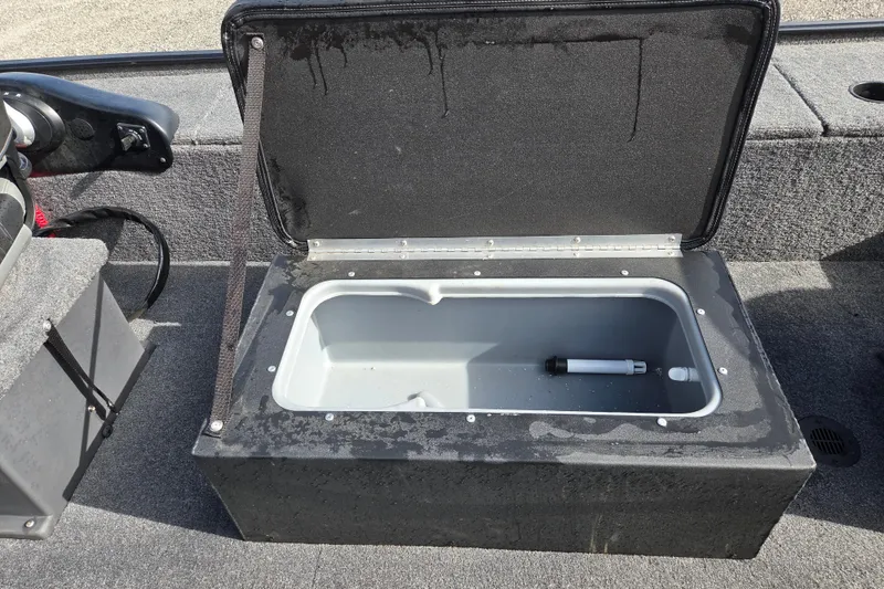 Slide: The Image of Open storage compartment on 2025 Tracker Panfish 17 boat, featuring a clean interior. - 13
