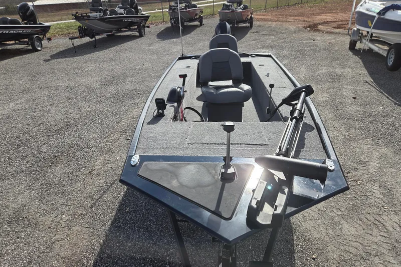 Slide: The Image of 2025 Tracker Panfish 17 boat displayed in a parking lot with other boats. - 2