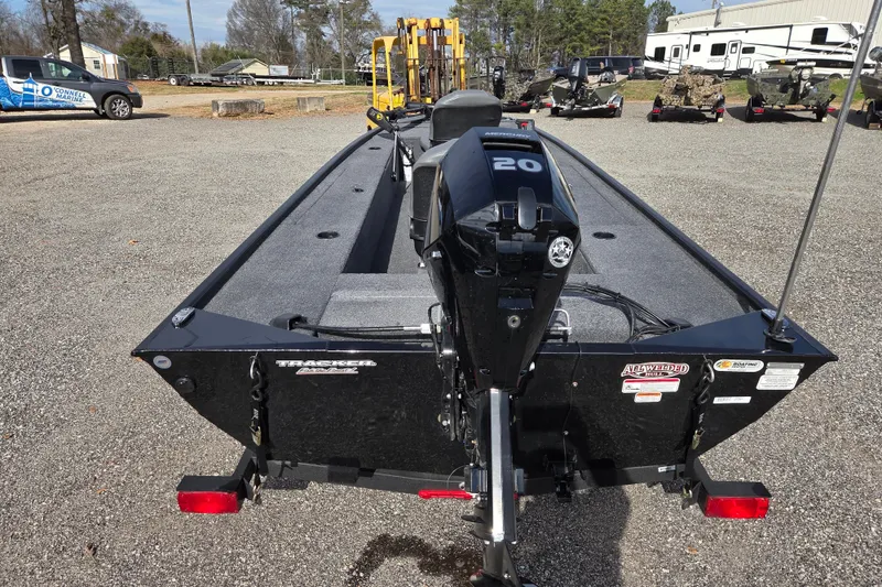 Slide: The Image of 2025 Tracker Panfish 17 boat with 20HP motor, parked outdoors on gravel. - 6
