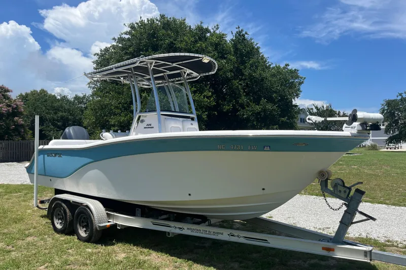 The Image of 2014 Sea Fox 226 Commander boat on trailer, parked outdoors under a clear sky. - 1