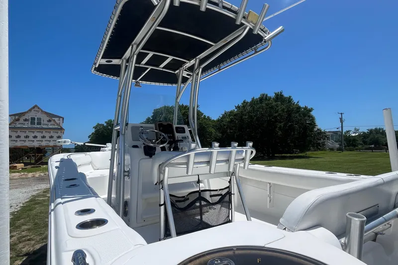 Slide: The Image of 2014 Sea Fox 226 Commander boat with T-top and console, parked outdoors. - 10