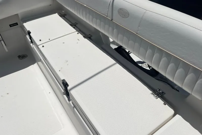 Slide: The Image of 2014 Sea Fox 226 Commander boat interior with white seating and storage compartments. - 26
