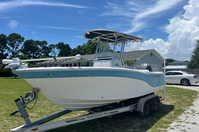 Slide: The Image of 2014 Sea Fox 226 Commander boat on trailer, parked in a grassy yard. - 7