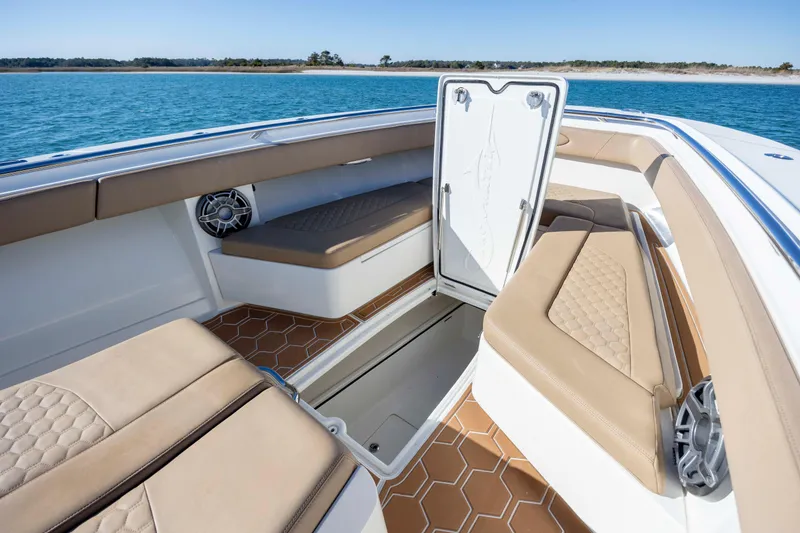 Slide: The Image of 2020 Blackwater 41 Tournament boat interior with tan seating and open storage compartment. - 15