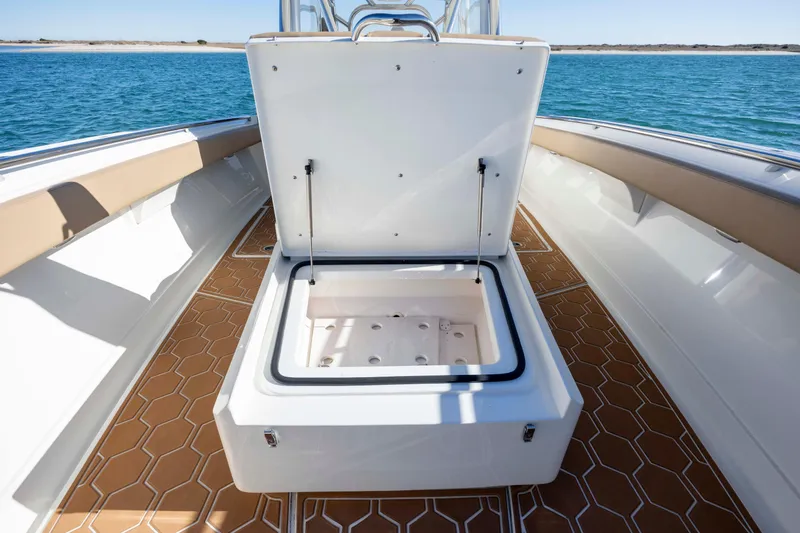 Slide: The Image of Open storage compartment on 2020 Blackwater 41 Tournament boat, featuring hexagonal deck pattern. - 20