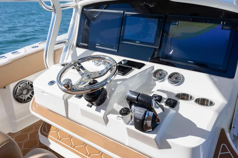 Slide: The Image of Control panel of 2020 Blackwater 41 Tournament boat with steering wheel and digital displays. - 33