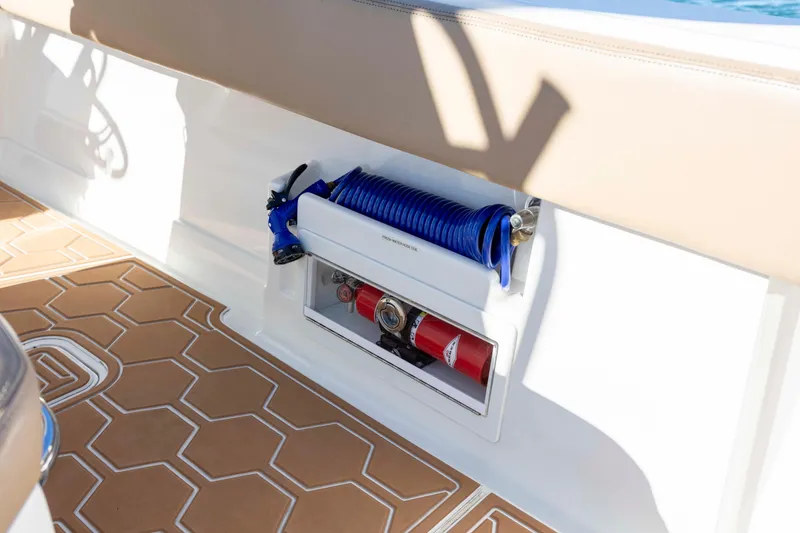 Slide: The Image of 2020 Blackwater 41 Tournament boat interior with coiled blue hose and fire extinguisher. - 48