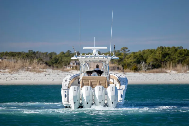 Slide: The Image of 2020 Blackwater 41 Tournament boat cruising near sandy shoreline. - 6