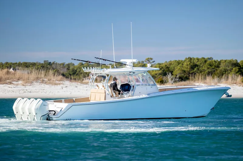 Slide: The Image of 2020 Blackwater 41 Tournament boat cruising on blue water near sandy shoreline. - 7