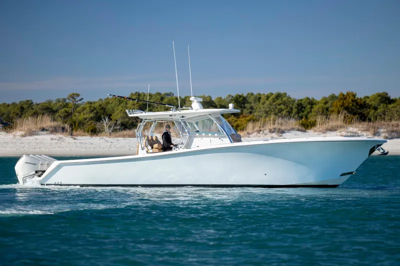 Slide: The Image of 2020 Blackwater 41 Tournament boat cruising near a sandy shoreline. - 8