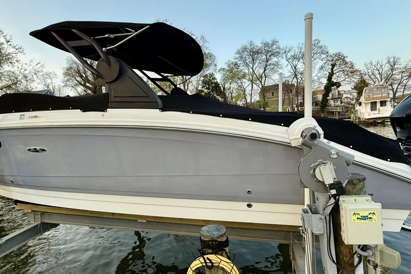 Slide: The Image of 2018 Sea Ray 290 Sundeck Outboard boat docked with black canopy. - 7